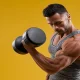 man performing forearm workout with dumbbells for bigger and stronger arms